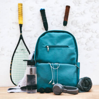 Shot of a sports bag and other items in an empty squash court