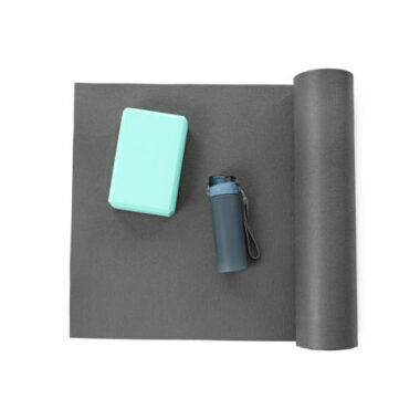 Grey exercise mat, yoga block and bottle of water isolated on white, top view