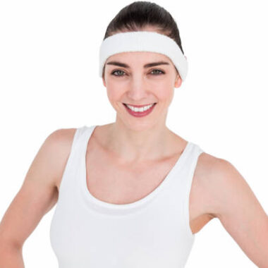 Female athlete posing with hands on hip on white background